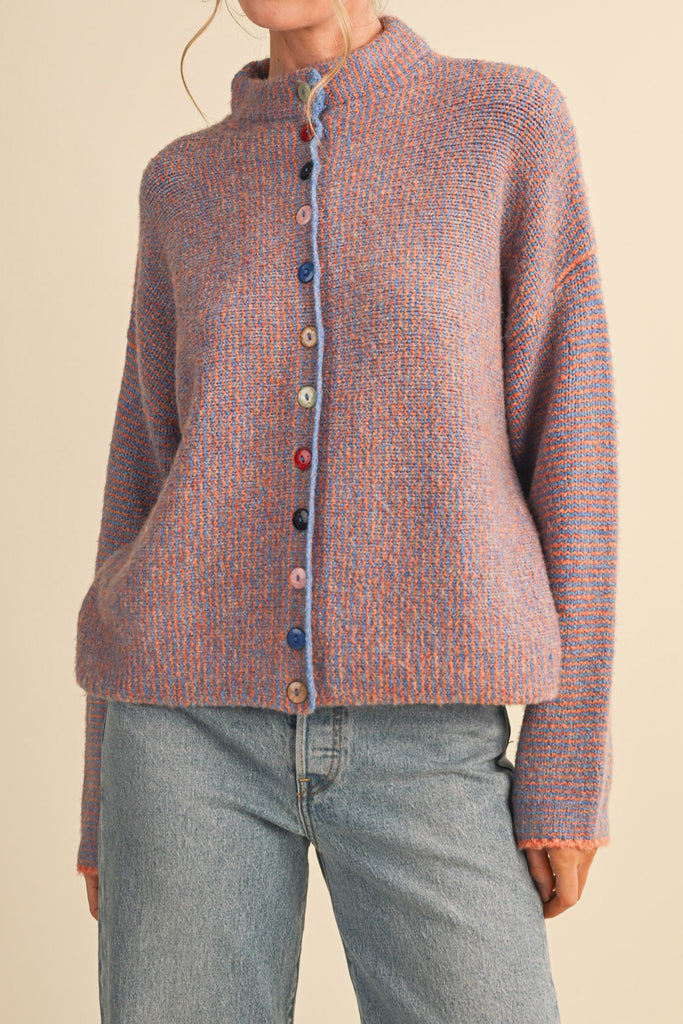 adorable orange and blue vertical striped cardigan with colorful button detailing.