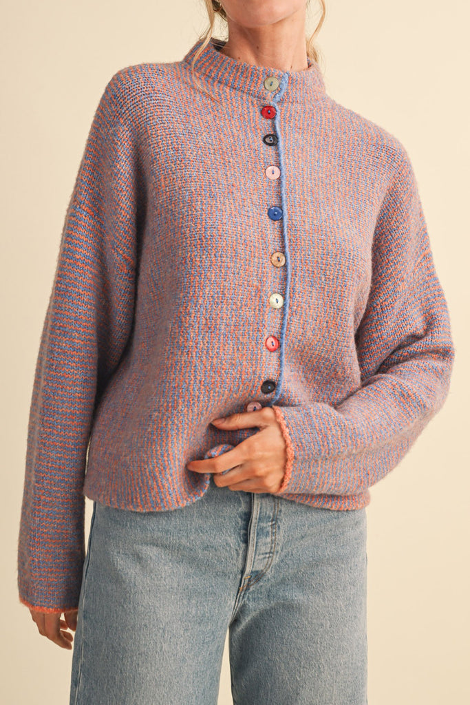 adorable orange and blue vertical striped cardigan with colorful button detailing.
