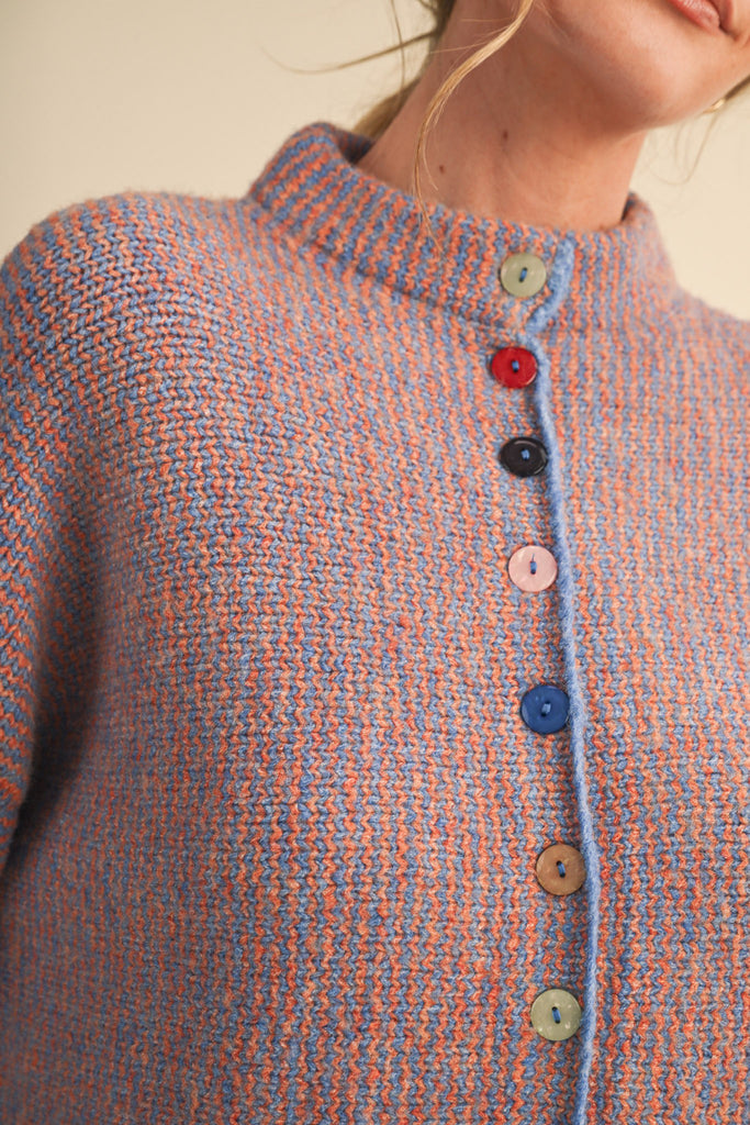 adorable orange and blue vertical striped cardigan with colorful button detailing.