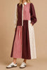 striking maxi dress with a mix print design in burgundy, black, pink, and white