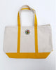 canvas tote with mustard yellow trim and colorfully embroidered personify flower logo
