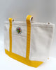 canvas tote with mustard yellow trim and colorfully embroidered personify flower logo