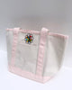 small canvas tote bag with pink straps and embroidered personify flower