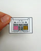 enamel pin featuring a colorful illustration of personify shop in chamblee, georgis