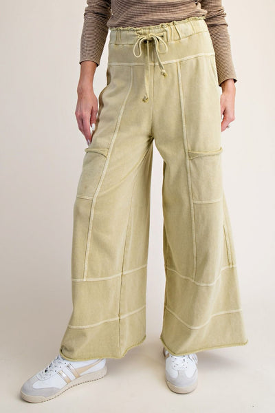 wide leg sweatpants in washed acid green with pockets and exposed seam detailing