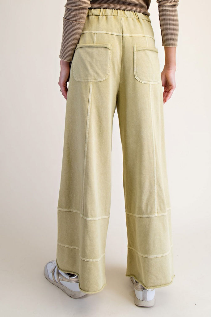 wide leg sweatpants in washed acid green with pockets and exposed seam detailing
