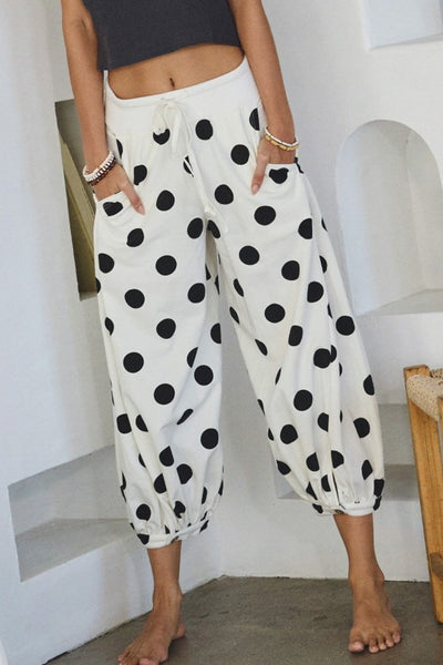 white lounge pants with black polka dots throughout