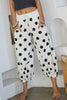 white lounge pants with black polka dots throughout