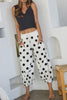 white lounge pants with black polka dots throughout