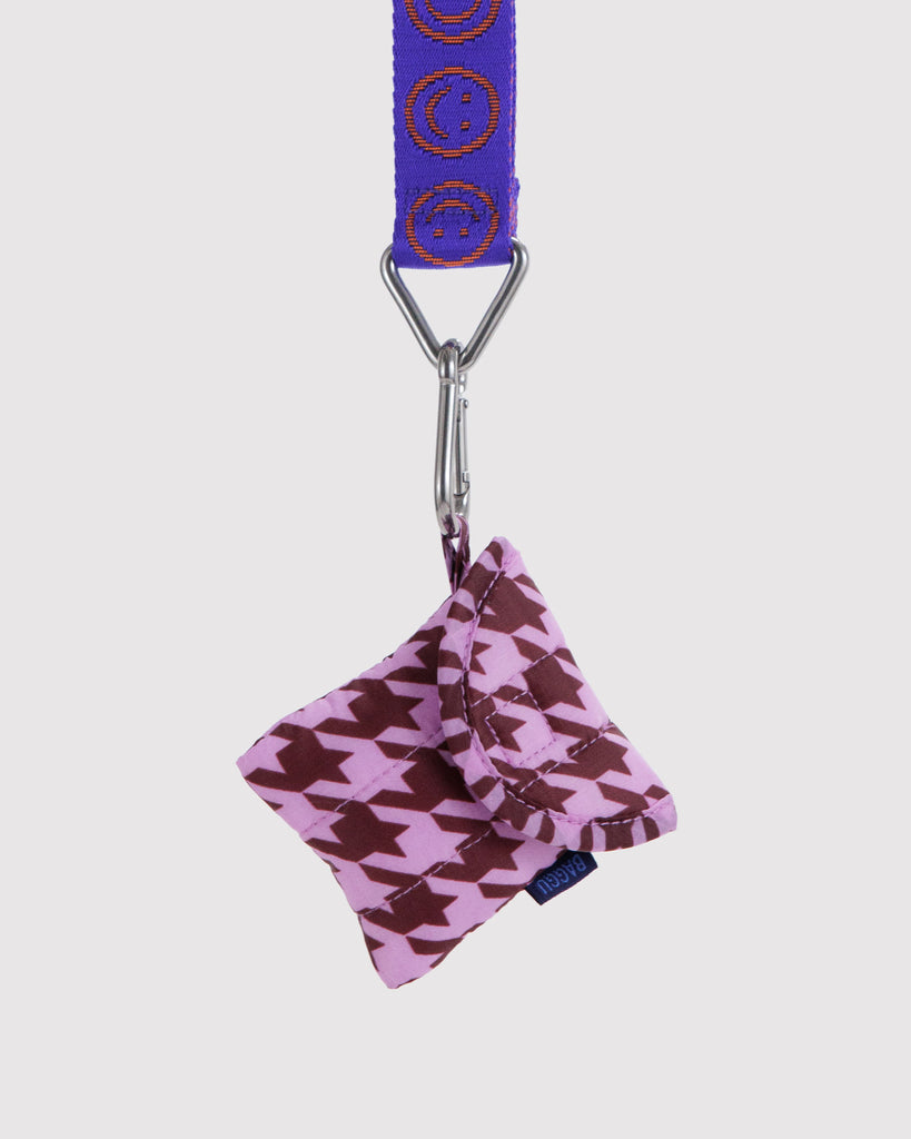 puffy earbuds case in a pink houndstooth print