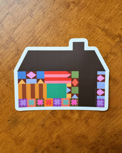 sticker in the shape of a house with a colorful quilt-inspired design