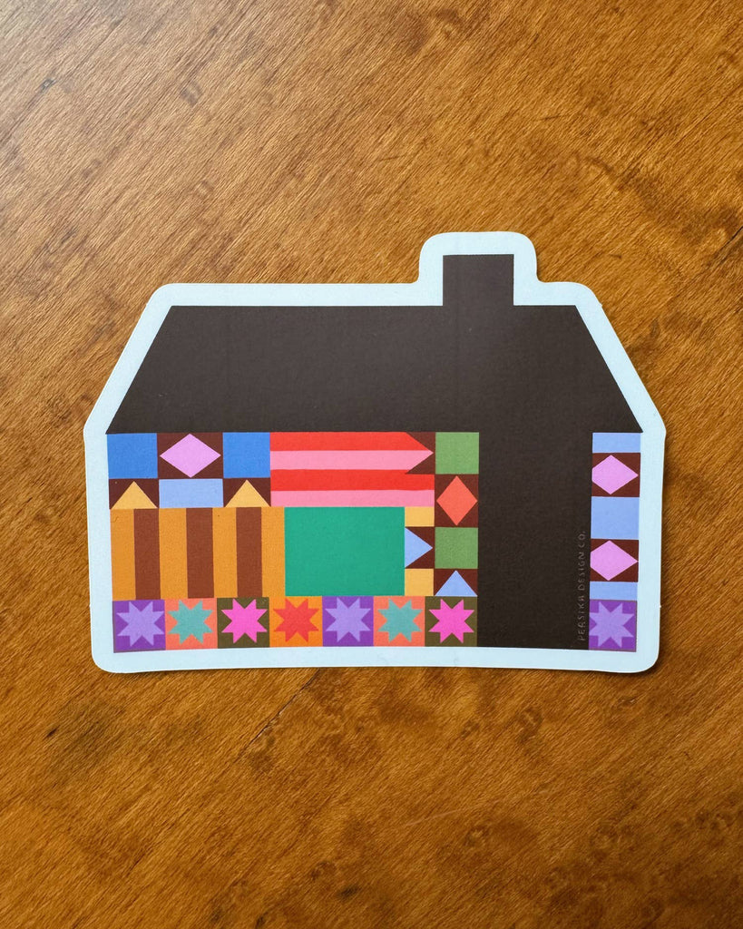 sticker in the shape of a house with a colorful quilt-inspired design