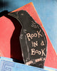 genuine leather bookmark in the shape of a rook with the message "rook in a book" 