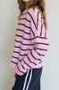 baby pink and black striped cardigan with a classic shape.