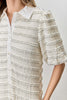 white mini dress with black trimmed ruffle details throughout