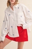 menswear-inspired button down top in crisp white with embroidered sailboats throughout