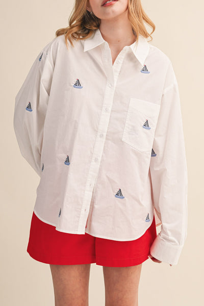 menswear-inspired button down top in crisp white with embroidered sailboats throughout