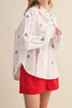 menswear-inspired button down top in crisp white with embroidered sailboats throughout