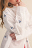 menswear-inspired button down top in crisp white with embroidered sailboats throughout