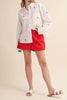 menswear-inspired button down top in crisp white with embroidered sailboats throughout