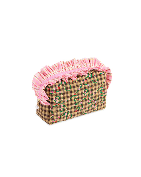 brown quilted pouch with ruffled pink zipper and embroidered details