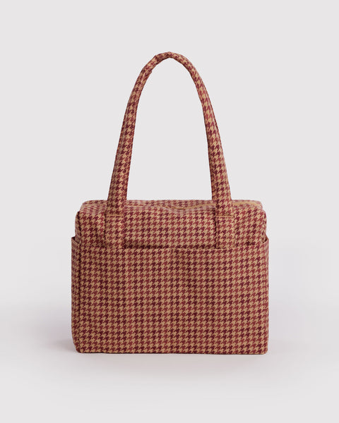 small carry-on bag in a tan houndstooth pattern