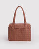 small carry-on bag in a tan houndstooth pattern