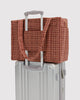small carry-on bag in a tan houndstooth pattern