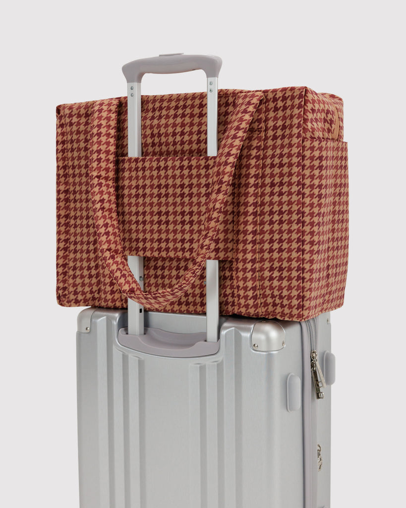 small carry-on bag in a tan houndstooth pattern