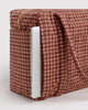 small carry-on bag in a tan houndstooth pattern