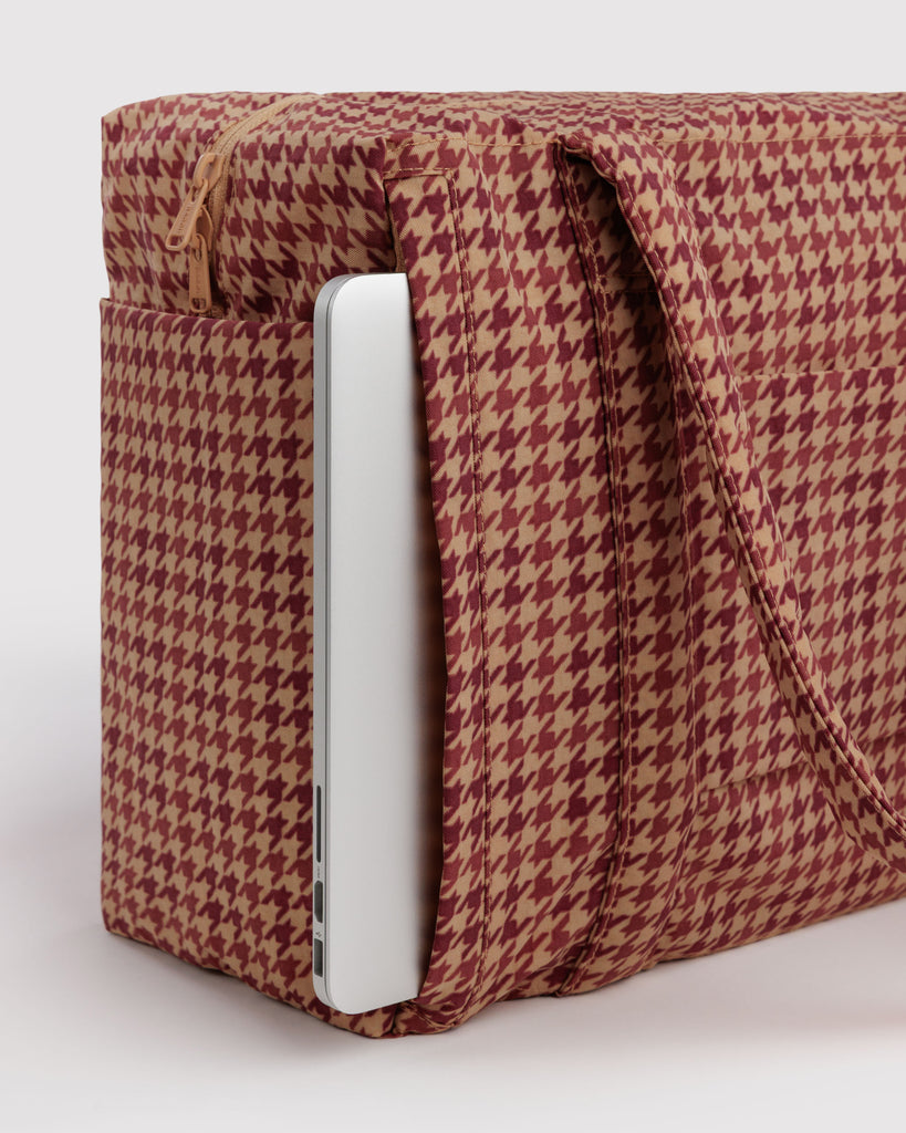 small carry-on bag in a tan houndstooth pattern