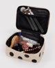 small cosmetic case in a cream and black polka dot pattern