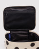 small cosmetic case in a cream and black polka dot pattern