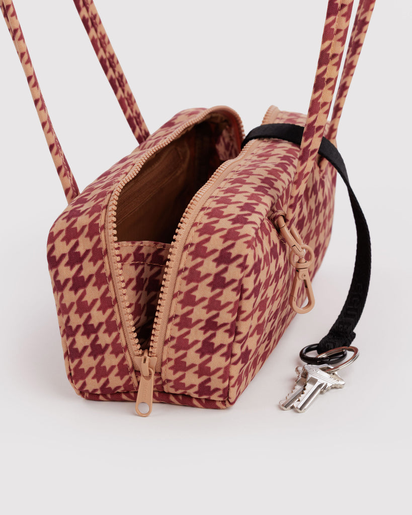small nylon bowler bag in a tan houndstooth pattern