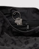 small nylon crescent bag from baggu in a charcoal colored ditsy floral pattern