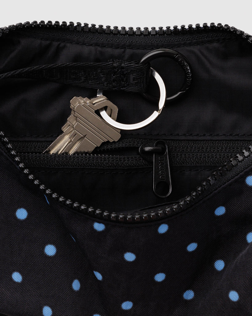 small nylon crescent bag from baggu in black with micro polka dots in sky blue