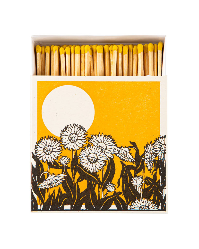 square matchbox of safety matches, sunflower fields