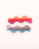 set of 2 hair clips with a squiggle design in sunset stripes