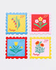 set of four leatherette coasters in the shape of colorful postage stamps