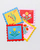 set of four leatherette coasters in the shape of colorful postage stamps
