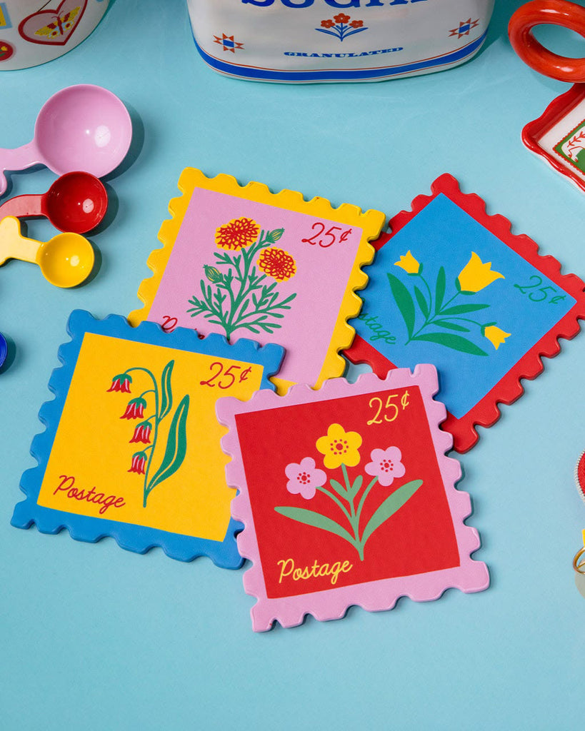 set of four leatherette coasters in the shape of colorful postage stamps