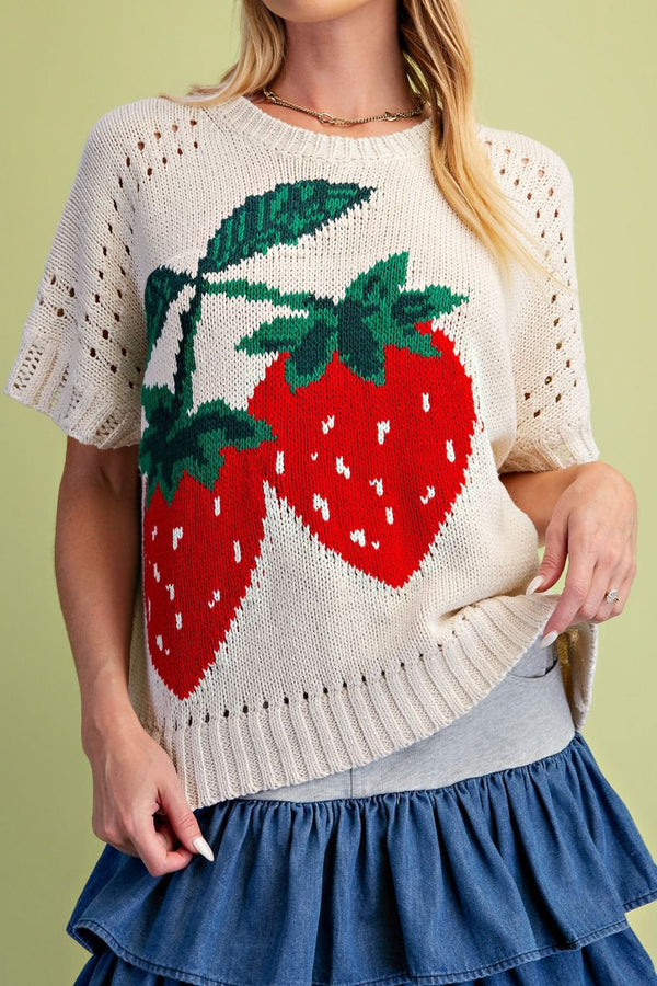 oversized knit top with a colorful strawberry graphic