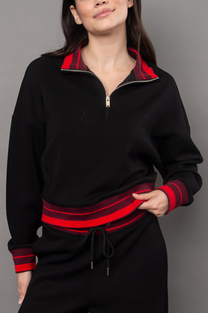 cozy black pullover with red racer stripe detailing.