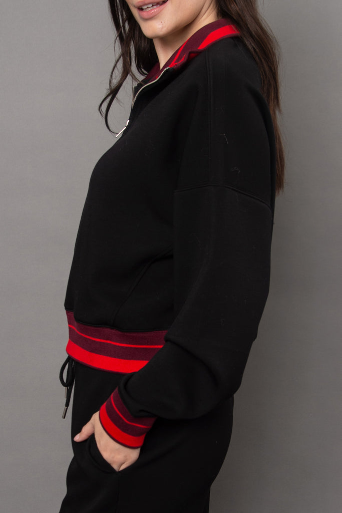 cozy black pullover with red racer stripe detailing.