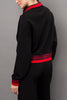 cozy black pullover with red racer stripe detailing.