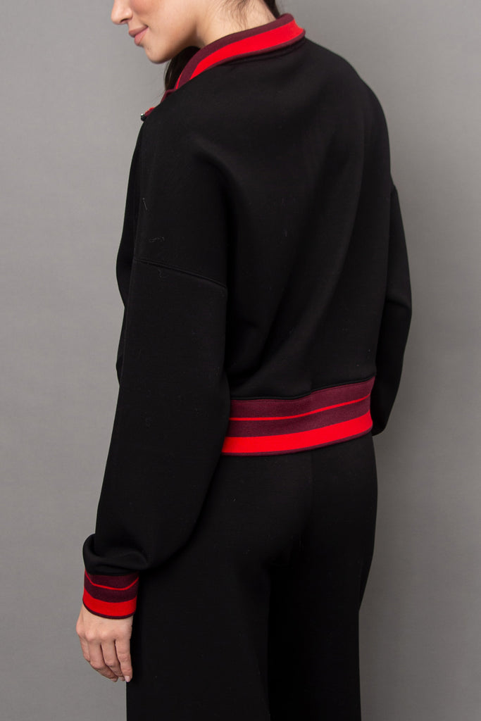 cozy black pullover with red racer stripe detailing.