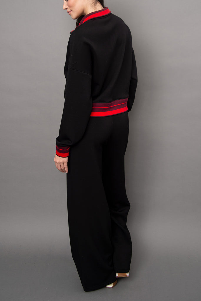 cozy black pullover with red racer stripe detailing.
