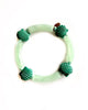 beaded bracelet with wide green beads and shell details