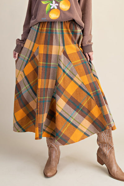 flowy midi skirt in a brown and orange plaid pattern