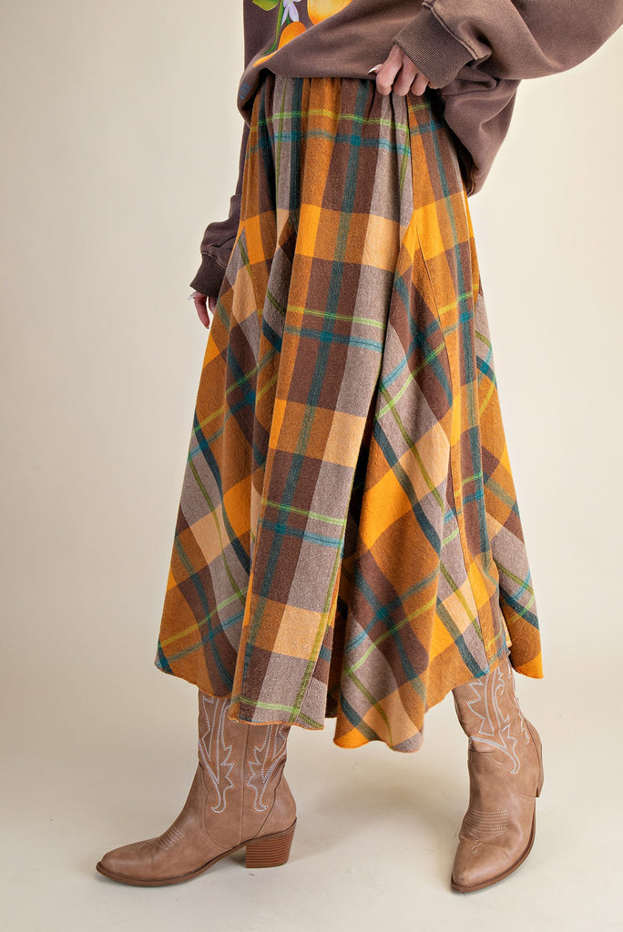 flowy midi skirt in a brown and orange plaid pattern